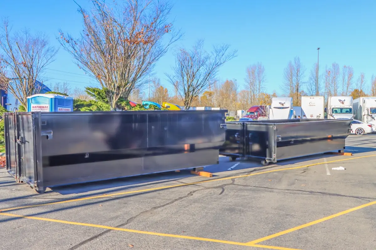 Professional dumpster rental service with roll-off container on residential driveway in Butner